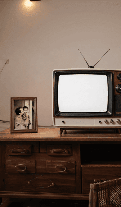 A living room with an old television playing archive footage